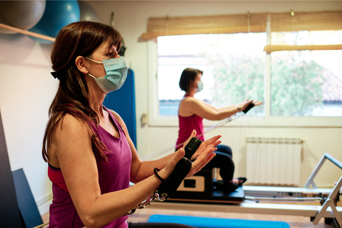 Two women exercising on machines