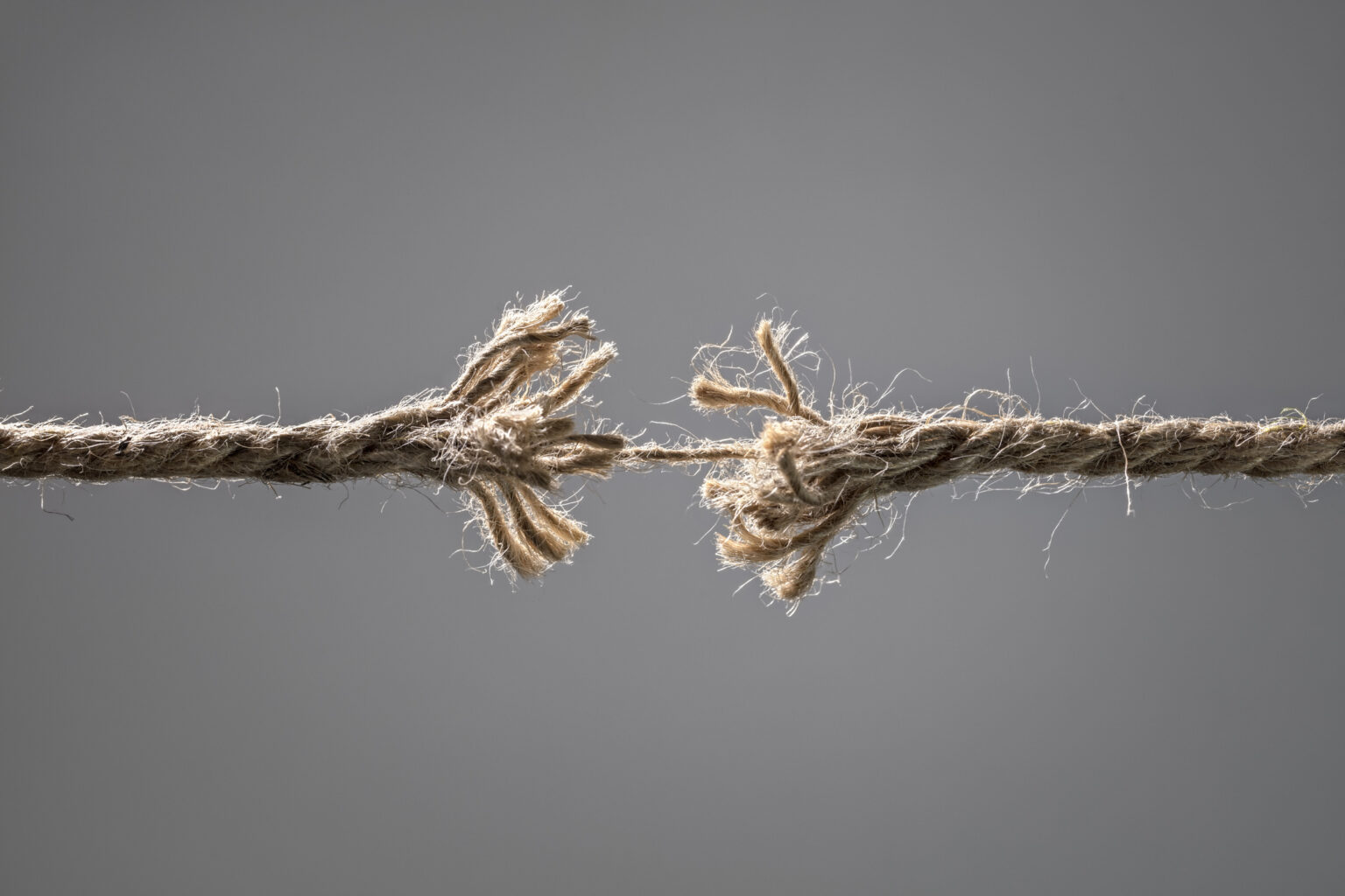 Image shows a frayed piece of rope about to break